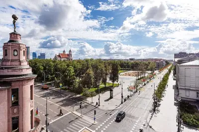 a city with a clock tower and a street at Luxury apartment in Gediminas avenue with terrace in Vilnius