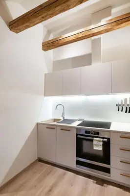 a white kitchen with a sink and a stove at Luxury apartment in Gedimino av. in Vilnius