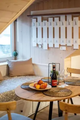 a table with a plate of fruit and a bottle of wine at Luxury apartment in Gedimino av. in Vilnius