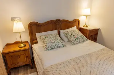 a bed with two pillows on it with two lamps at Doma3 Luxury Vilnius Apartment in Vilnius