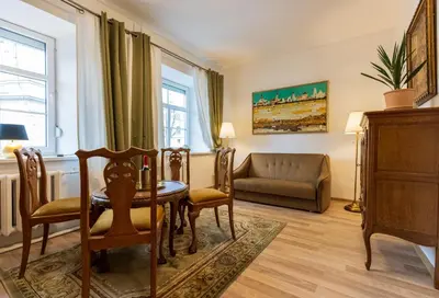 a living room with a table and chairs and a couch at Doma3 Luxury Vilnius Apartment in Vilnius