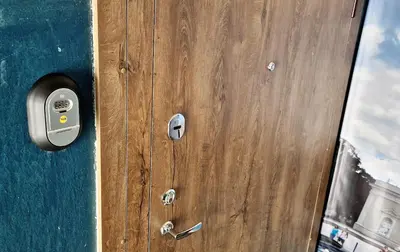 a close up of a wooden door with a handle at Doma3 Luxury Vilnius Apartment in Vilnius