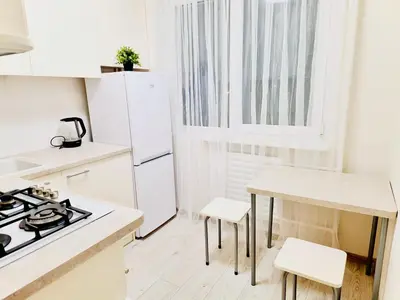 a kitchen with white appliances and a table and chairs at M&M Apartment V SELF CHECK-IN in Panevėžys