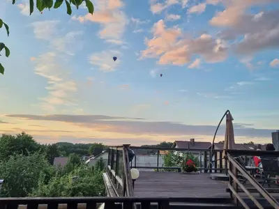 a kite is flying in the sky on a deck at ODM&A apartment in Vilnius