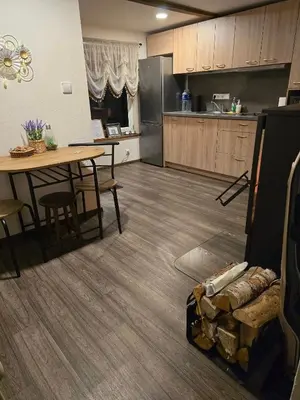 a kitchen and dining room with a table and a couch at ODM&A apartment in Vilnius
