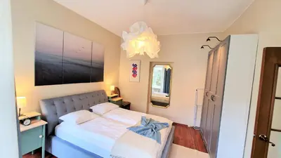 a bedroom with a bed with a blue bow on it at Rudi4 Luxury Vilnius Apartment in Vilnius