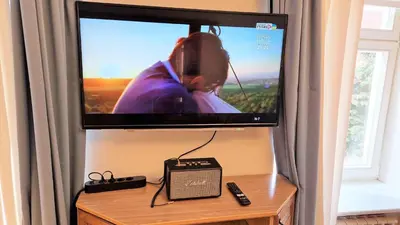 a flat screen tv on top of a table at Rudi4 Luxury Vilnius Apartment in Vilnius