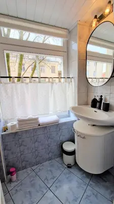 a bathroom with a sink and a toilet and a mirror at Rudi4 Luxury Vilnius Apartment in Vilnius