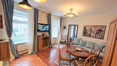 a living room with a couch and a table at Rudi4 Luxury Vilnius Apartment in Vilnius