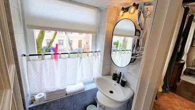 a bathroom with a sink and a mirror at Rudi4 Luxury Vilnius Apartment in Vilnius