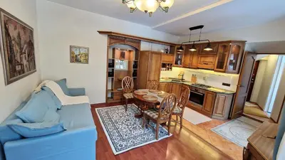 a living room with a blue couch and a table at Rudi4 Luxury Vilnius Apartment in Vilnius