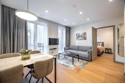 a living room with a couch and a table at Brand New Downtown Apartments by Reside Baltic in Vilnius