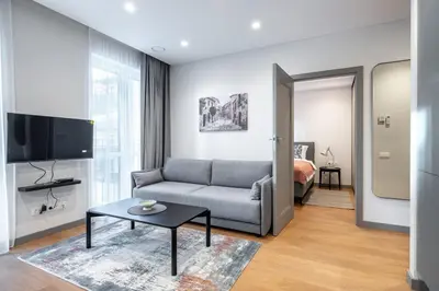 a living room with a couch and a tv at Brand New Downtown Apartments by Reside Baltic in Vilnius