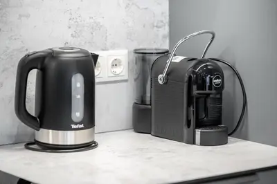a coffee maker and a toaster on a counter at Brand New Downtown Apartments by Reside Baltic in Vilnius