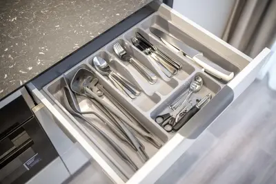 a drawer filled with silver utensils in a kitchen at Brand New Downtown Apartments by Reside Baltic in Vilnius