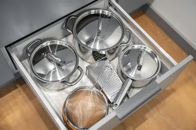 a drawer filled with metal pans and strainer at Brand New Downtown Apartments by Reside Baltic in Vilnius
