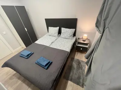 a bedroom with a bed with two pillows on it at City Life in Vilnius