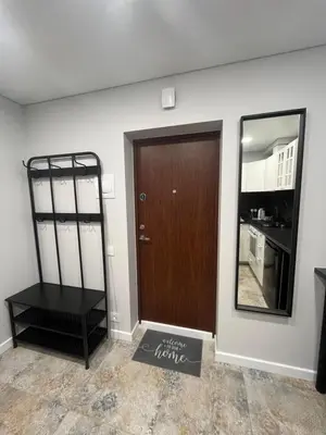 a room with a brown door and a mirror at City Life in Vilnius