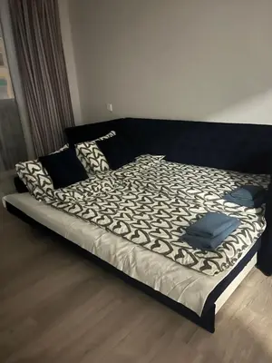 a large bed with a black and white comforter at City Life in Vilnius