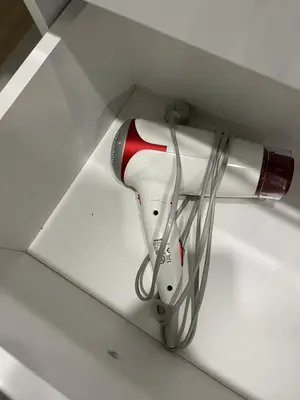 a hairdryer hanging from a wall in a ceiling at City Life in Vilnius