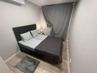 a small bedroom with a bed with a window at City Life in Vilnius