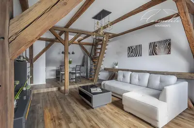 a living room with a white couch and a table at Spacious sky Carmelite apartment in Vilnius