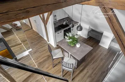 an overhead view of a kitchen and a table and chairs at Spacious sky Carmelite apartment in Vilnius