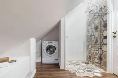 a laundry room with a washer and dryer at Spacious sky Carmelite apartment in Vilnius