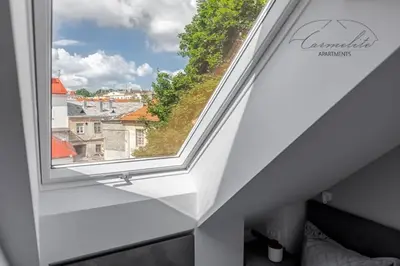 a window in a white room with a view at Spacious sky Carmelite apartment in Vilnius