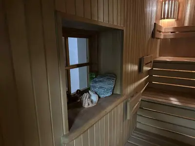 a small window in a room with a bed in it at Guest House Vilnius in Vilnius