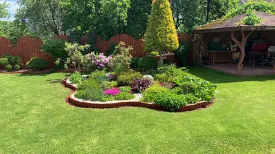 a garden with flowers and a gazebo at Guest House Vilnius in Vilnius