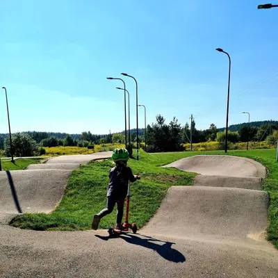 a young boy riding a skateboard down a road at Guest House Vilnius in Vilnius