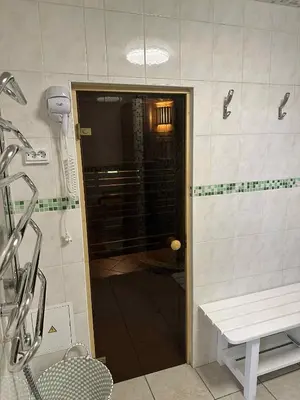 a shower with a glass door in a bathroom at Guest House Vilnius in Vilnius