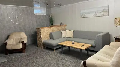a living room with a couch and a table and chairs at Guest House Vilnius in Vilnius