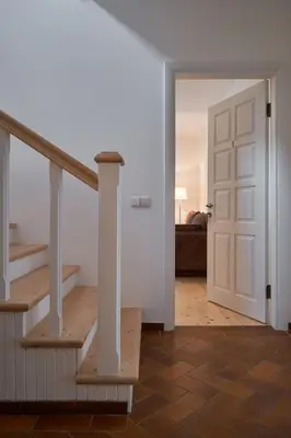a hallway with a staircase and a room with a door at Jonavos alpakų svečių namai in Jonava