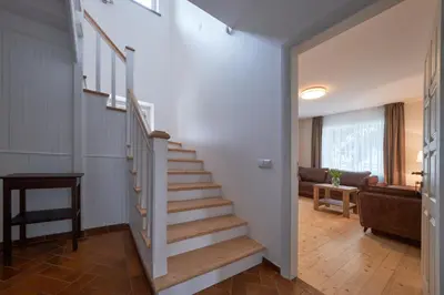 a staircase in a house with a living room at Jonavos alpakų svečių namai in Jonava