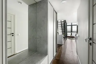 a hallway with white walls and a wooden floor at Modern Loft Walk to Center Fast Wi-Fi in Vilnius