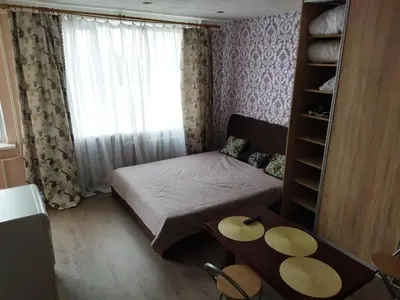 a small room with a bed and a window at Itaja apartment 50 in Šiauliai