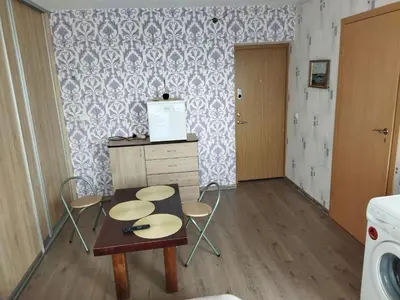 a kitchen with a table and chairs in a room at Itaja apartment 50 in Šiauliai