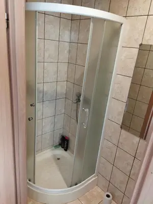 a shower with a glass door in a bathroom at Itaja apartment 50 in Šiauliai