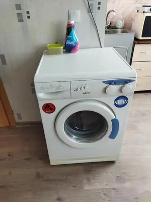 a washer and dryer sitting in a kitchen at Itaja apartment 50 in Šiauliai