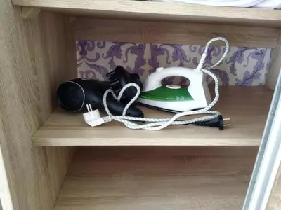 a shelf with a phone and a tea kettle at Itaja apartment 50 in Šiauliai
