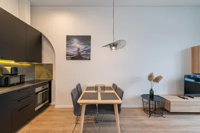 a kitchen with a table and a dining room at Shanti barracks apartment by Polo Apartments in Kaunas