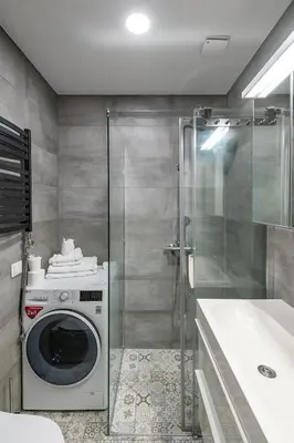 a washing machine in a bathroom with a shower at Shanti barracks apartment by Polo Apartments in Kaunas