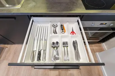 a drawer with silver utensils on a table at Shanti barracks apartment by Polo Apartments in Kaunas