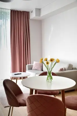 a living room with two tables and a couch at Parko Aveniu Apartamentai B4 in Birštonas