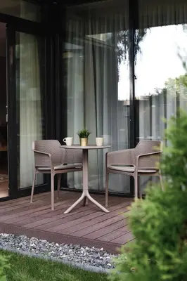 a table and two chairs on a patio at Parko Aveniu Apartamentai B4 in Birštonas