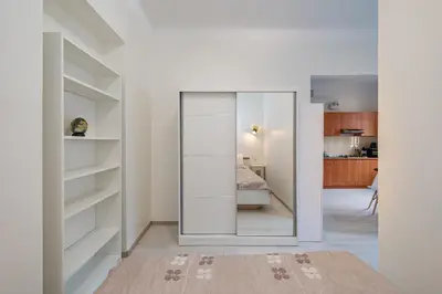a room with a mirror and a bedroom at Sophisticated Old town apartment by Polo Apartments in Kaunas