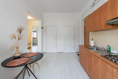 a kitchen with a black table and a sink at Sophisticated Old town apartment by Polo Apartments in Kaunas