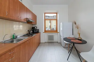a kitchen with a sink and a refrigerator at Sophisticated Old town apartment by Polo Apartments in Kaunas